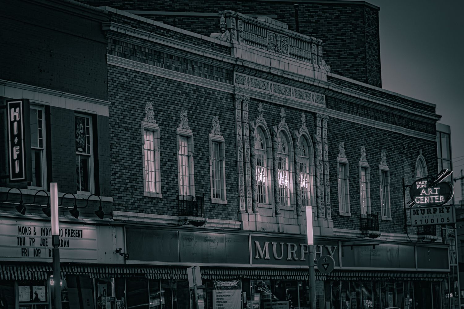 Historic brick building facade with ornate architectural details illuminated at night.
