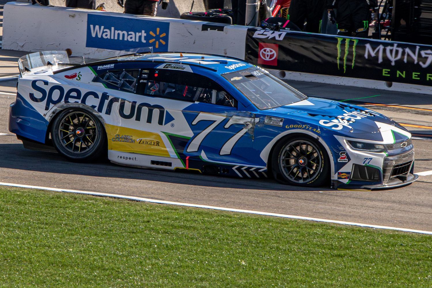 Carson Hocevar drives down pit road with a flat right front tire during the AutoTrader 400 on February 22nd 2026 at EchoPark Speedway