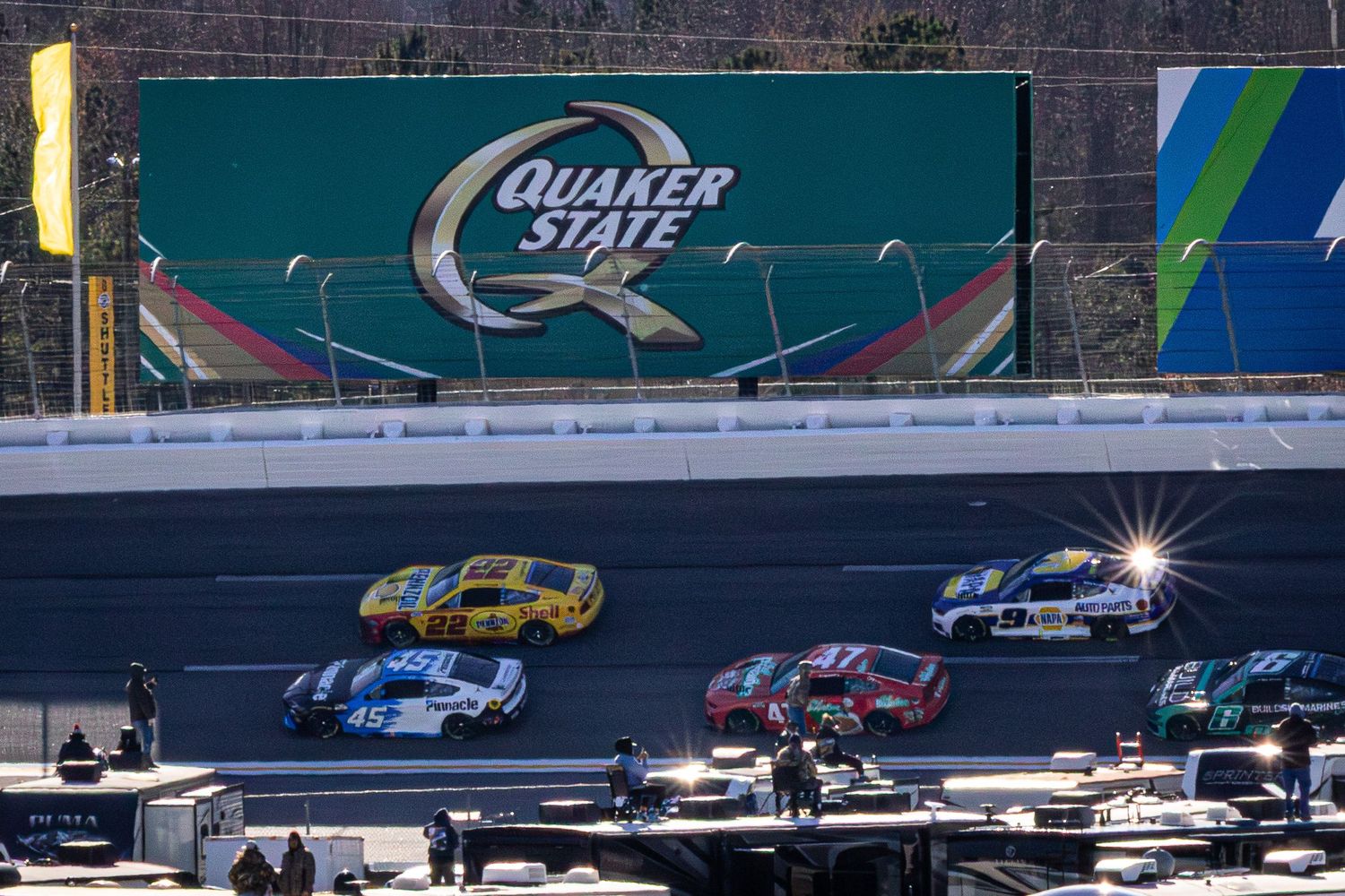 Race cars speed past the Quaker State wall advertisement during during the AutoTrader 400 on February 22nd 2026 at EchoPark Speedway
