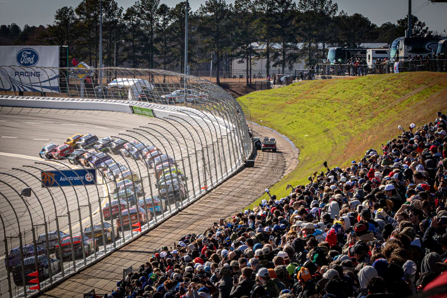Packed grandstands of racing fans watch NASCAR vehicles compete during the AutoTrader 400 on February 22nd 2026 at EchoPark Speedway