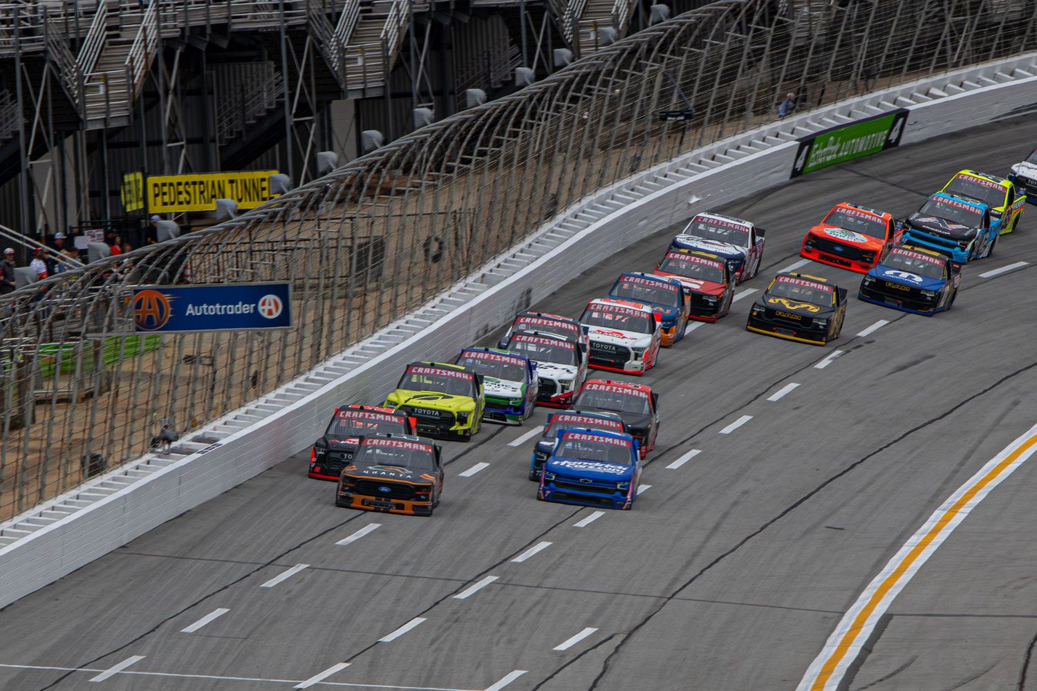 Wide shot of NASCAR trucks racing during the Fr8 Racing 208 at EchoPark Speedway on February 21st 2026.