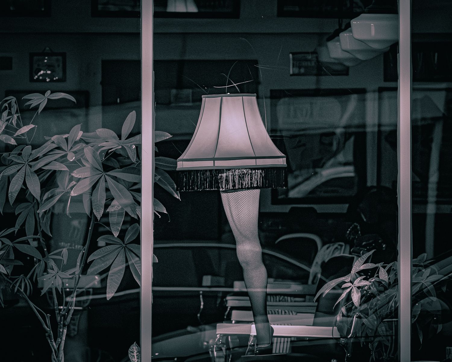Dimly lit interior space with vintage-style lamp fixtures and window reflections.