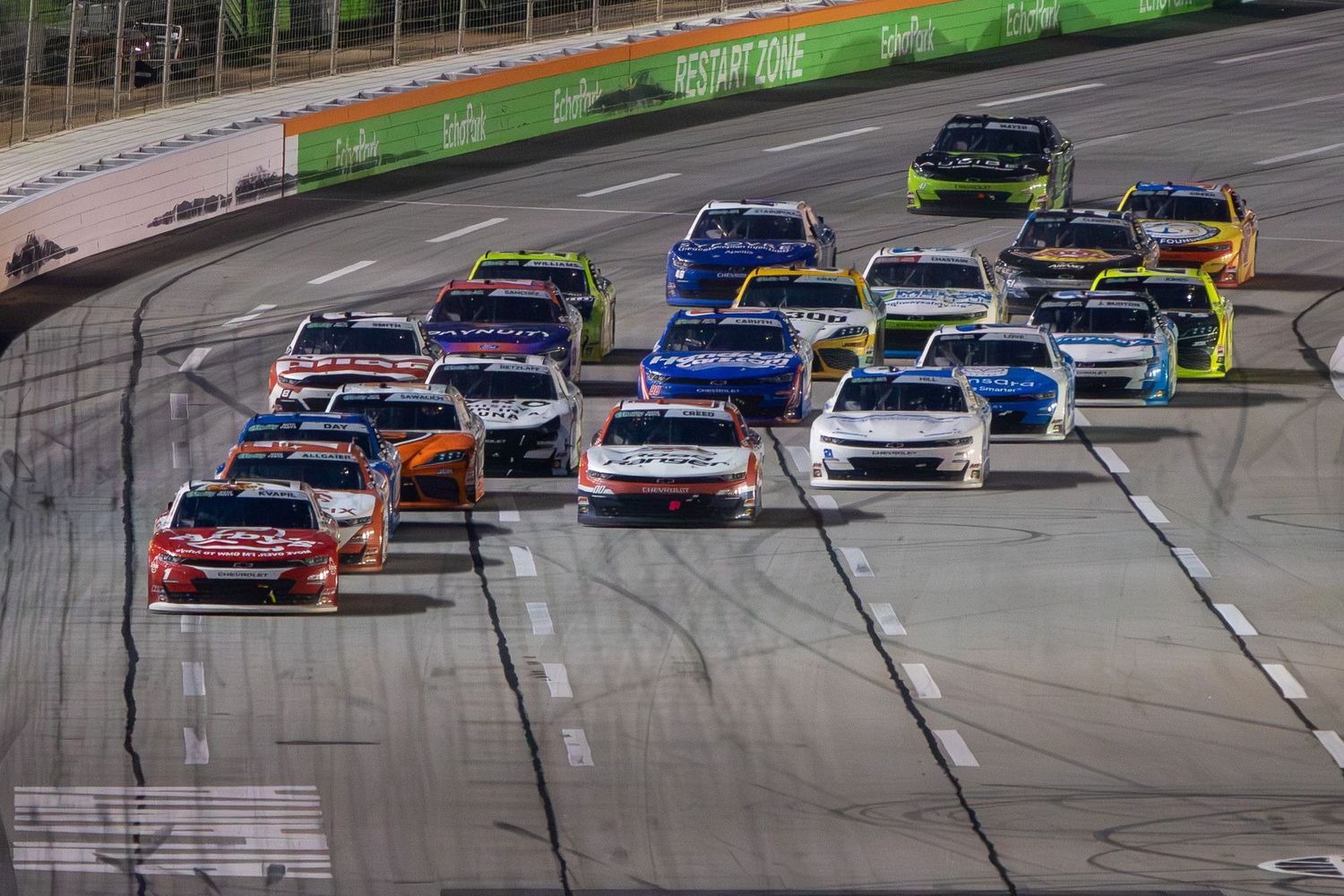 Pack of NASCAR race cars competing closely together during the Bennet Transportation & Logistics 250 on February 21st 2026
