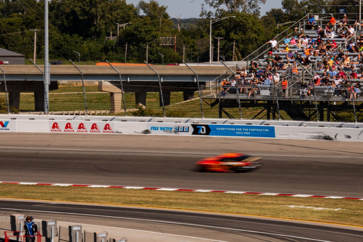 Aerial view of NASCAR race cars competing on a professional speedway track.