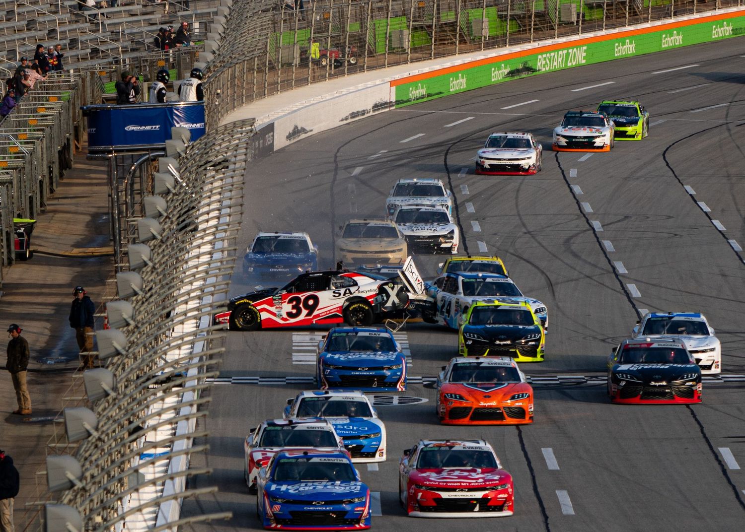 NASCAR vehicles collide during intense racing action during the Bennet Transportation & Logistics 250