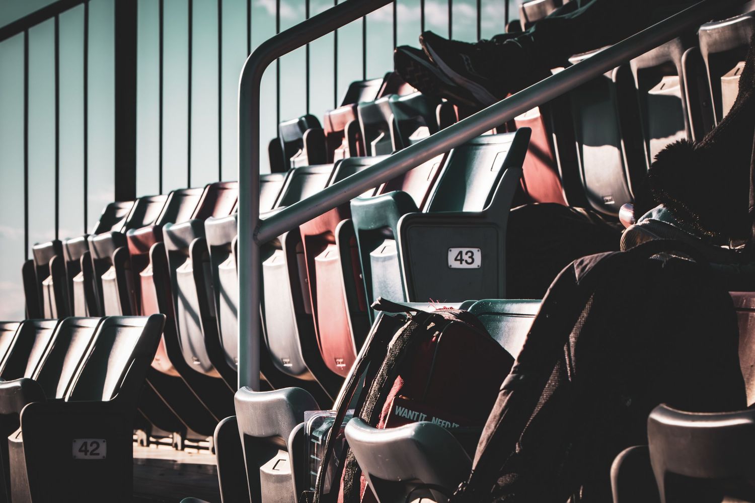 Empty stadium seats create geometric patterns in dramatic lighting.