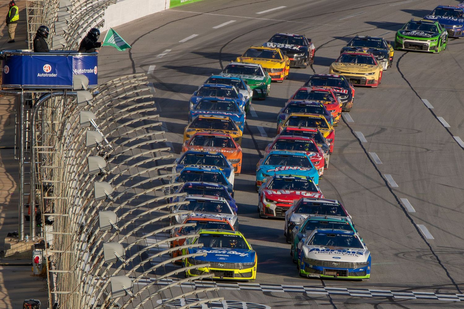 NASCAR stock cars racing in tight formation of the frontstretch during the AutoTrader 400 on February 22nd 2026 at EchoPark Speedway
