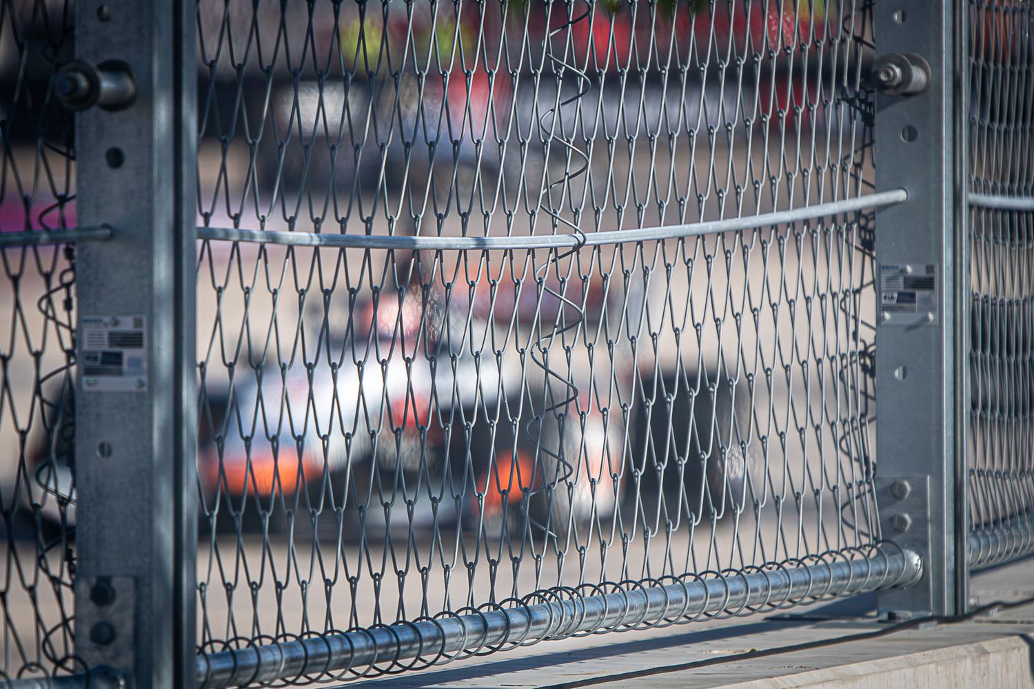 A metal security gate with a diamond pattern closes off a storefront entrance.