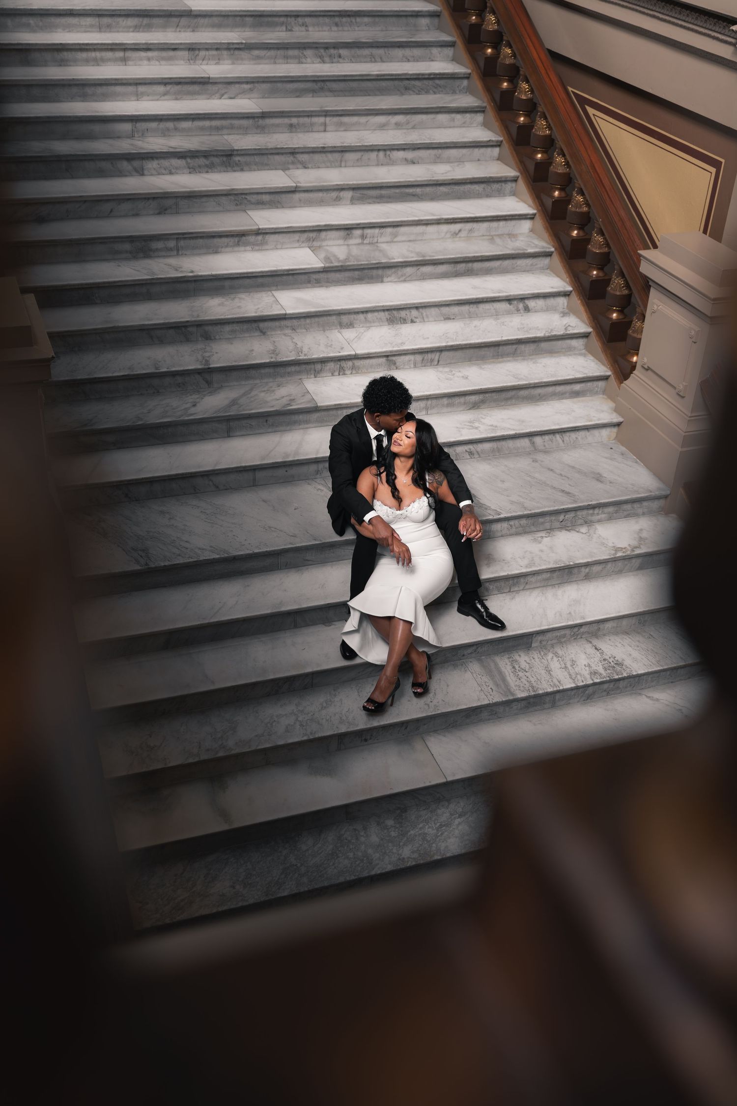 Bride and groom share a moment on the stairs of the Indiana Statehouse
