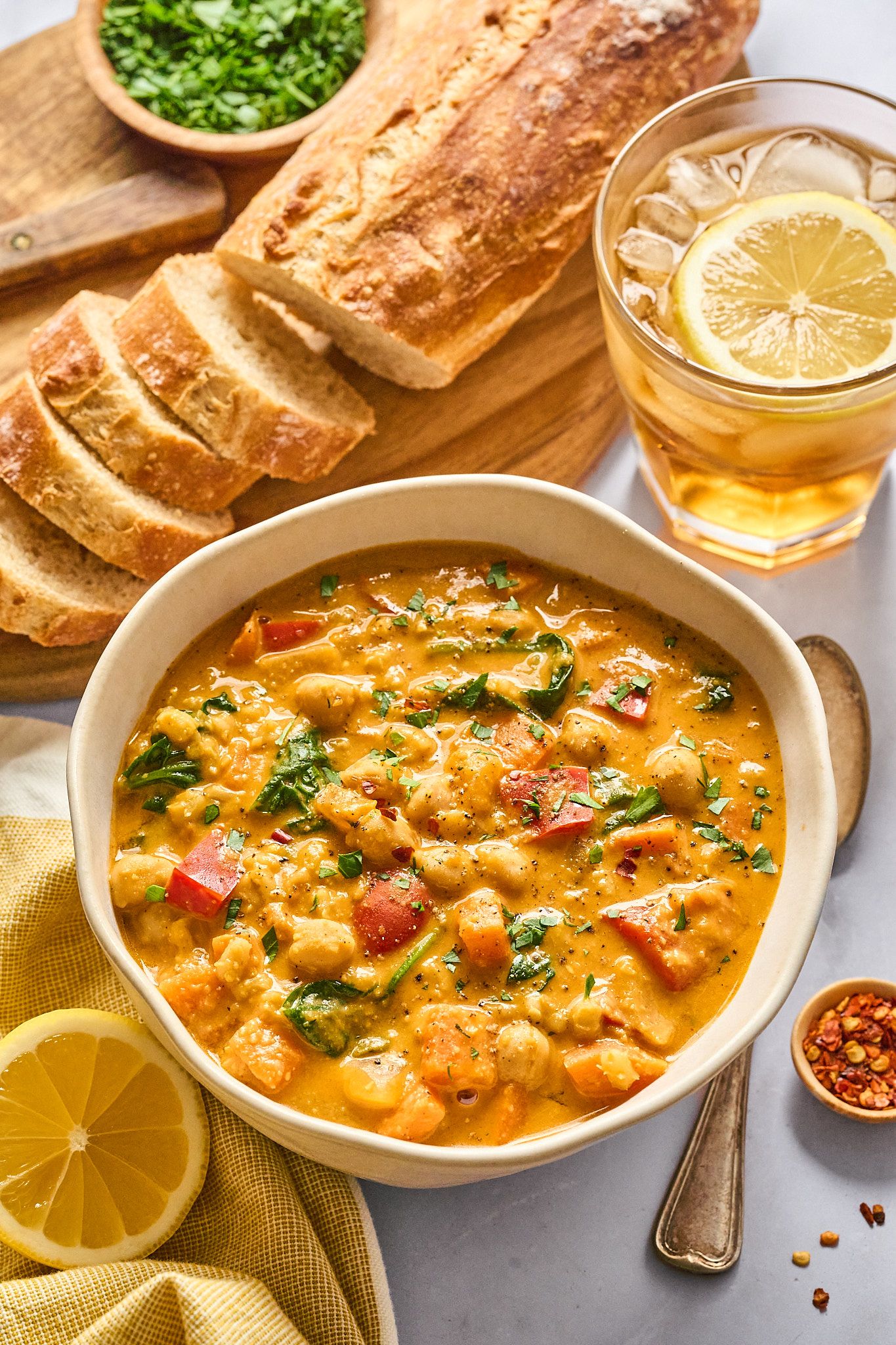 Styled recipe shot with casual dishes, napkins, and fresh ingredients in warm light