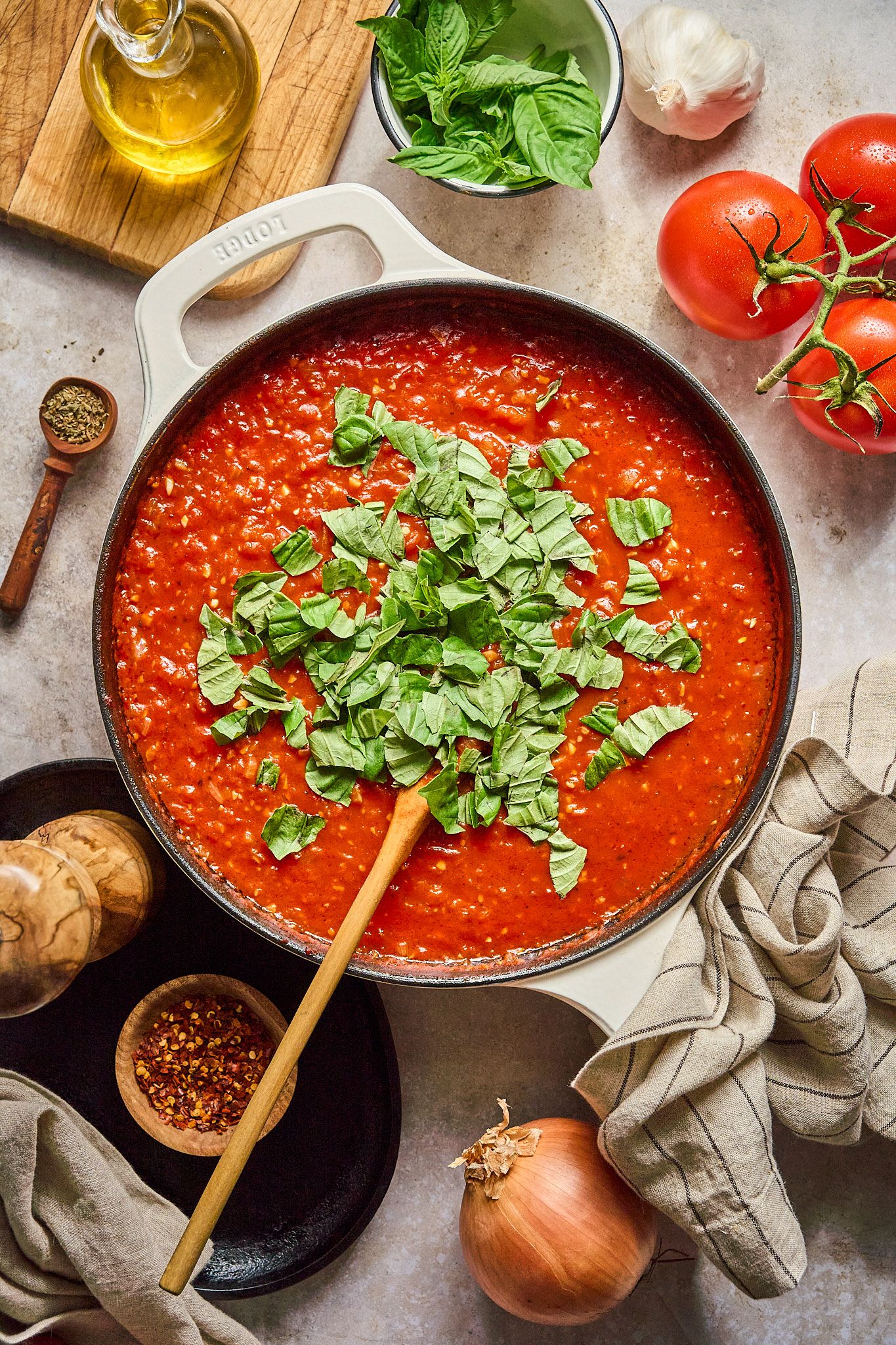 Styled recipe shot with casual dishes, napkins, and fresh ingredients in warm light