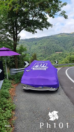 Purple equipment cover on roadside with mountain landscape in background.