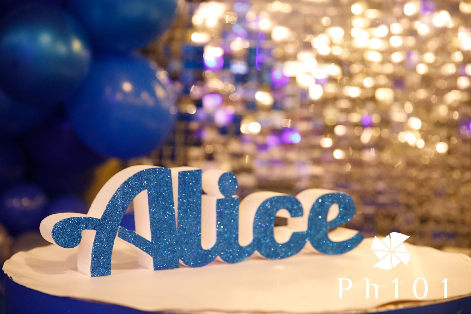 Illuminated decorative text display with bokeh lights in the background.