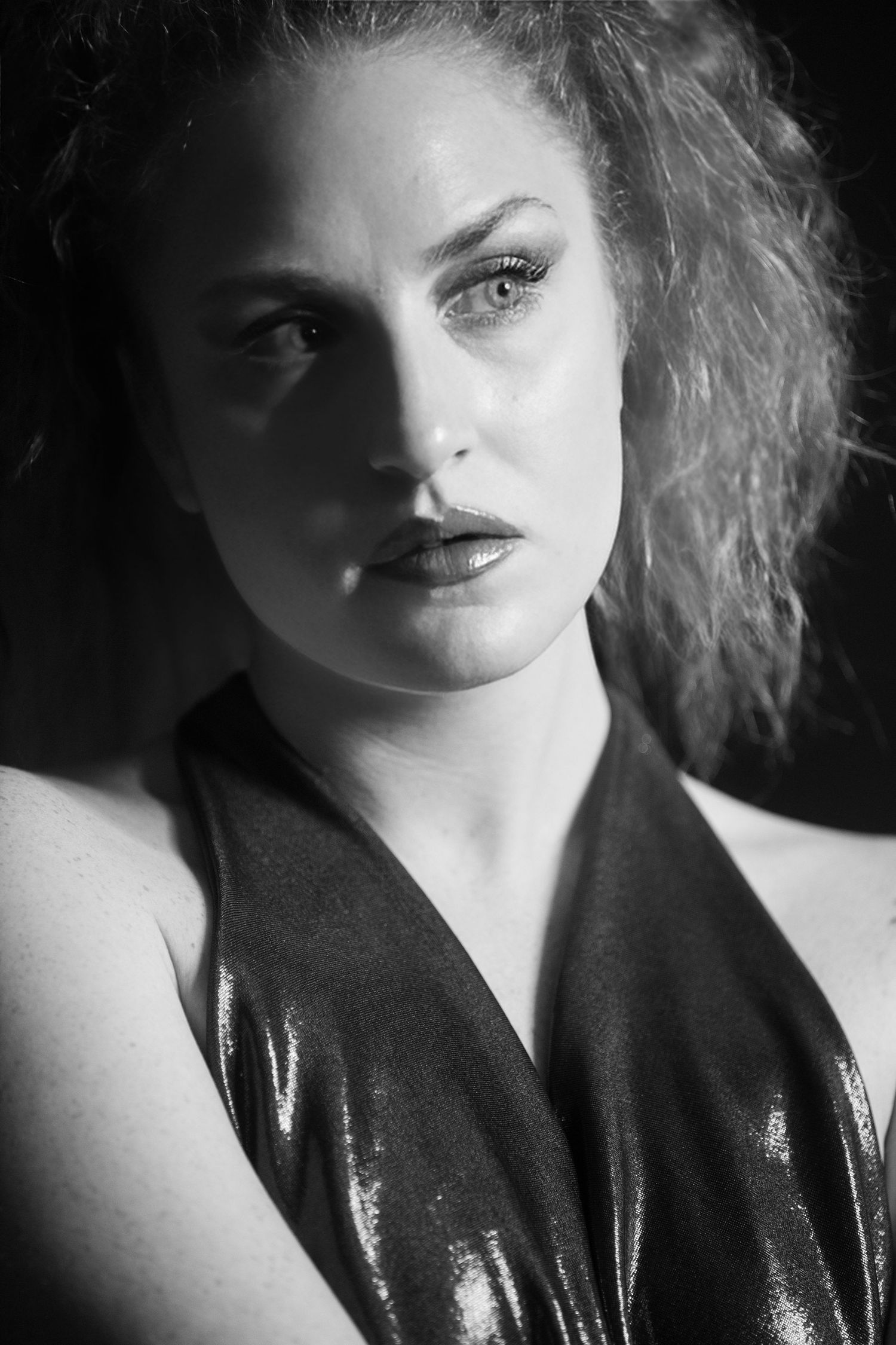 Film noir style black and white portrait series with dramatic vintage lighting.