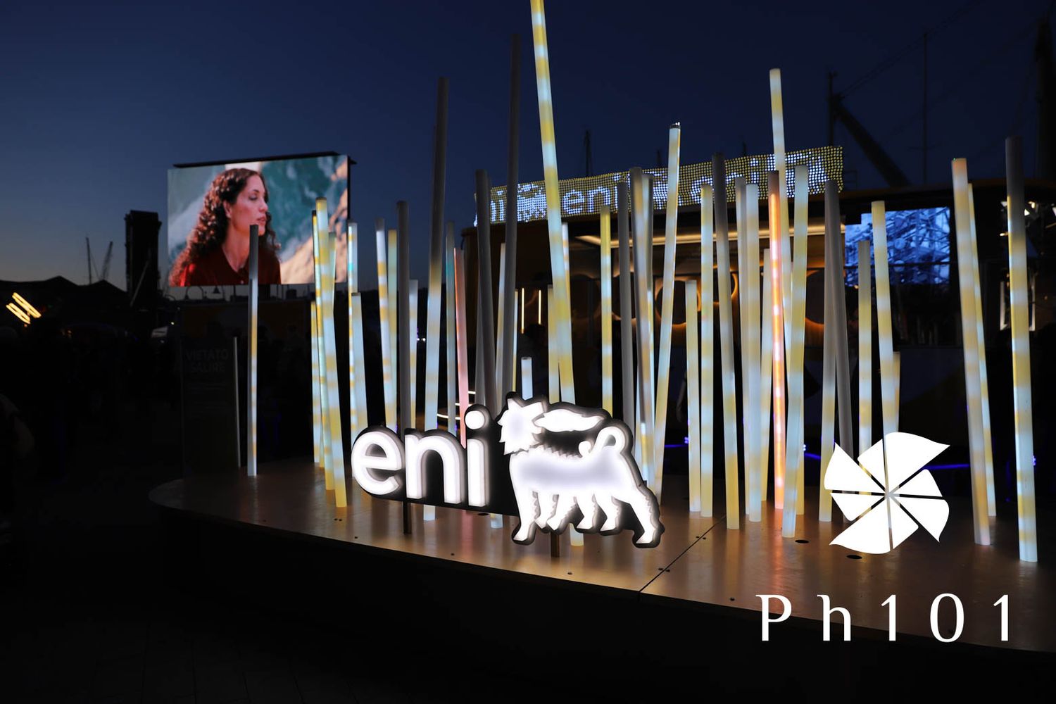 Illuminated vertical light installations displayed outdoors at night.