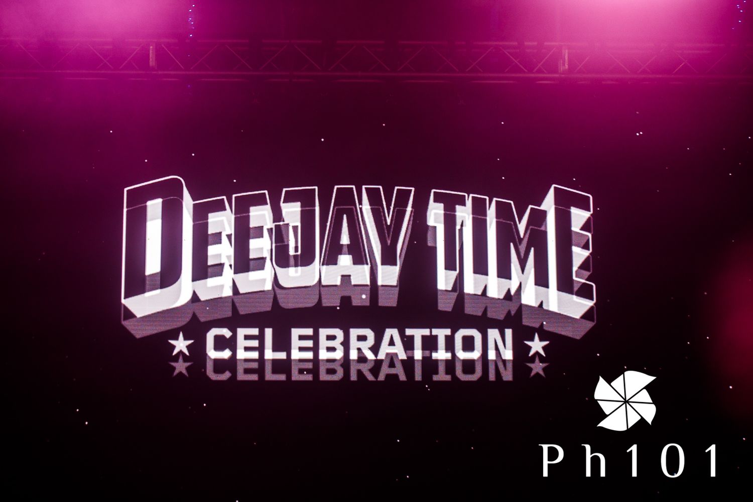 Purple-tinted concert venue signage displaying 'DEEJAY TIME CELEBRATION'.