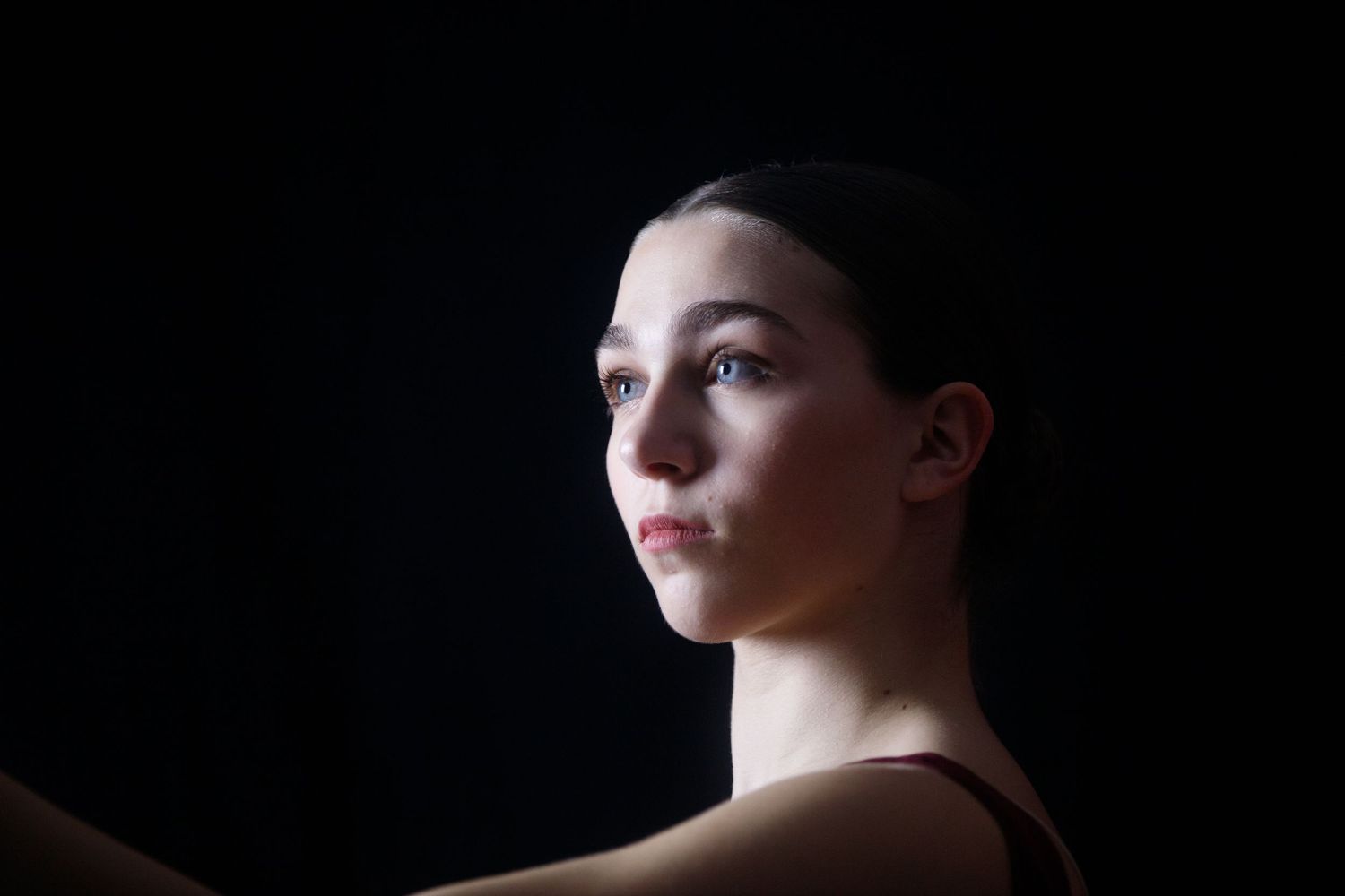 Dramatic side profile portraits against dark background showing emotional expressions.