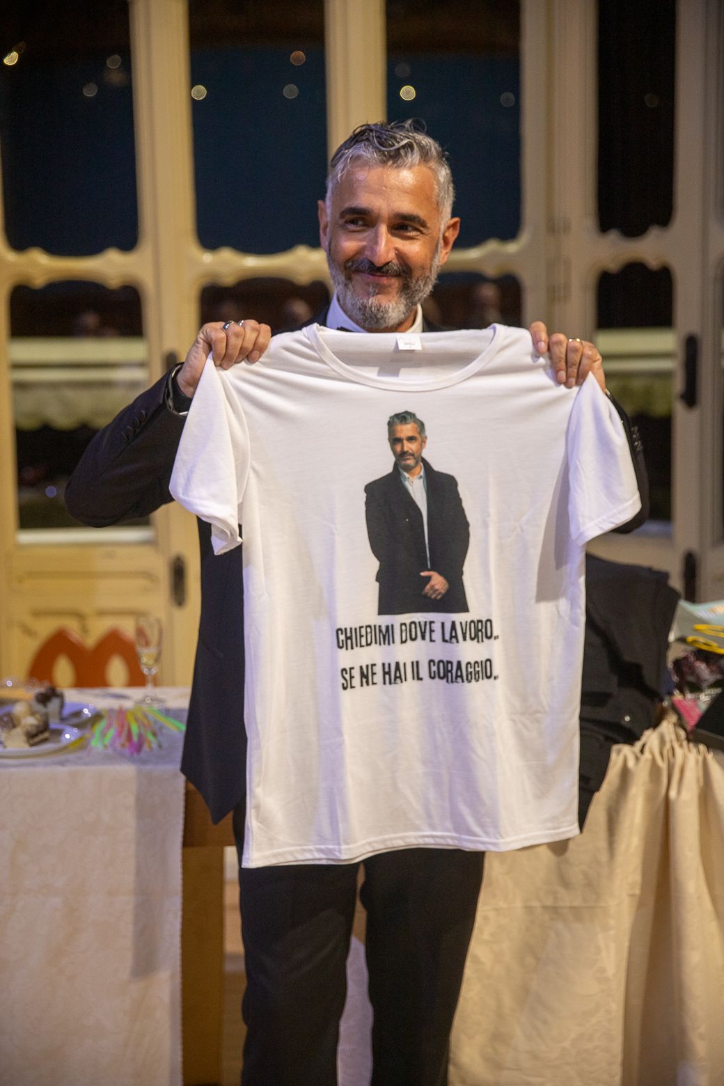 Display of white t-shirts with printed messages at formal event.