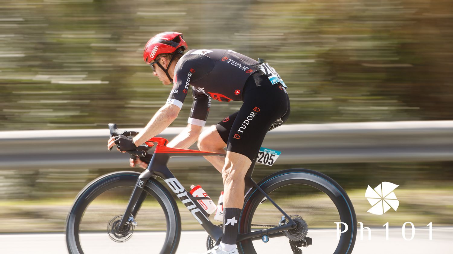 Cyclists race along a road with motion blur showing their speed and intensity.