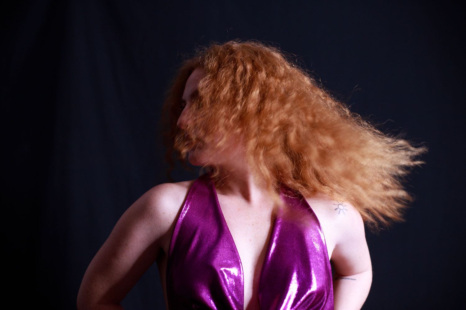 Dynamic fashion poses in purple dress against dark background.
