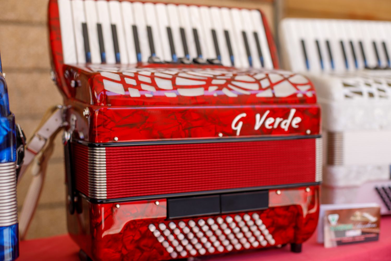 Collection of red and white accordions displayed in a row.