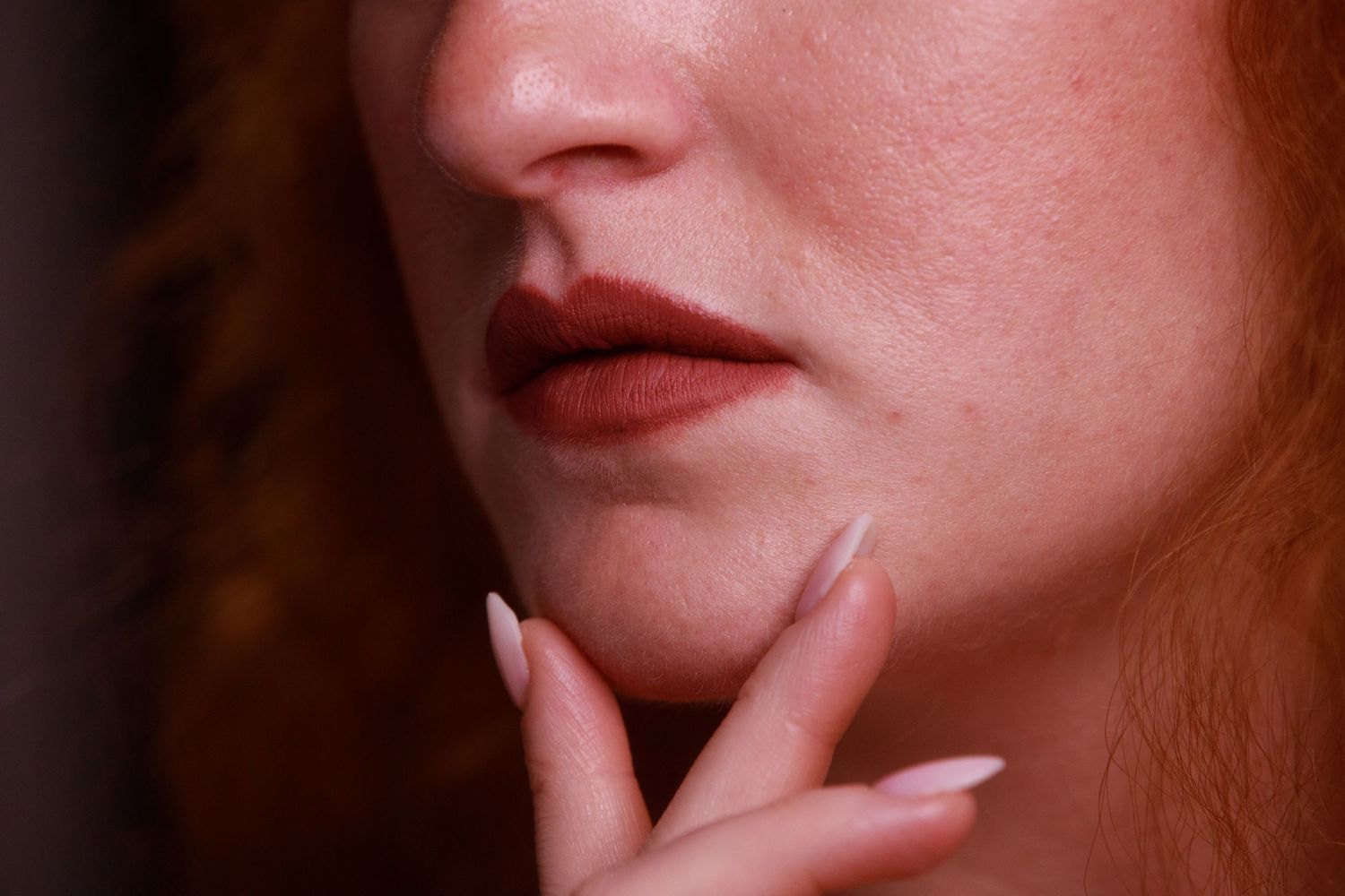 Artistic close-up shots of red lips and facial features against blue background.