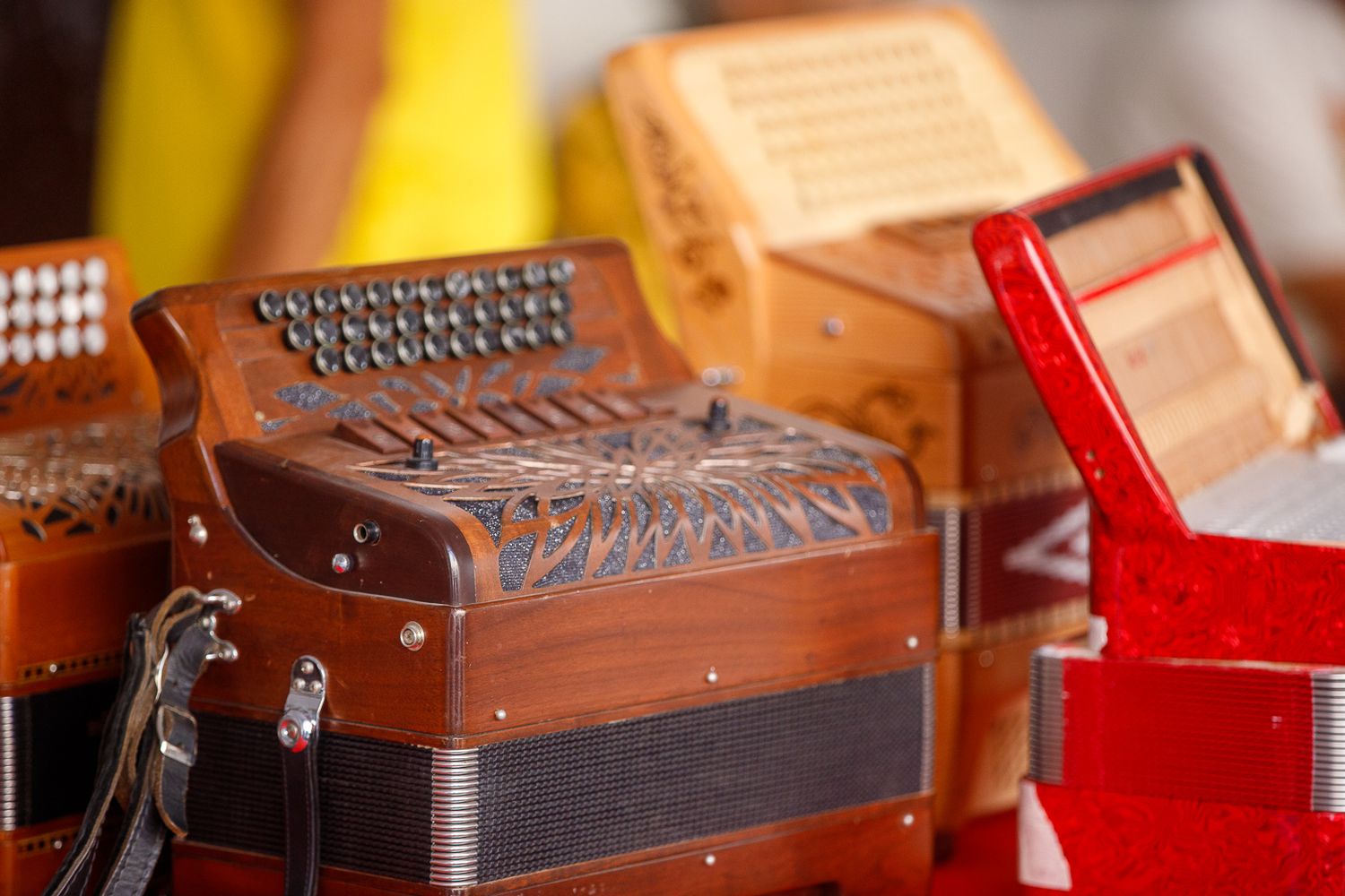 Close-up of vintage wooden accordions with ornate buttons and keys.