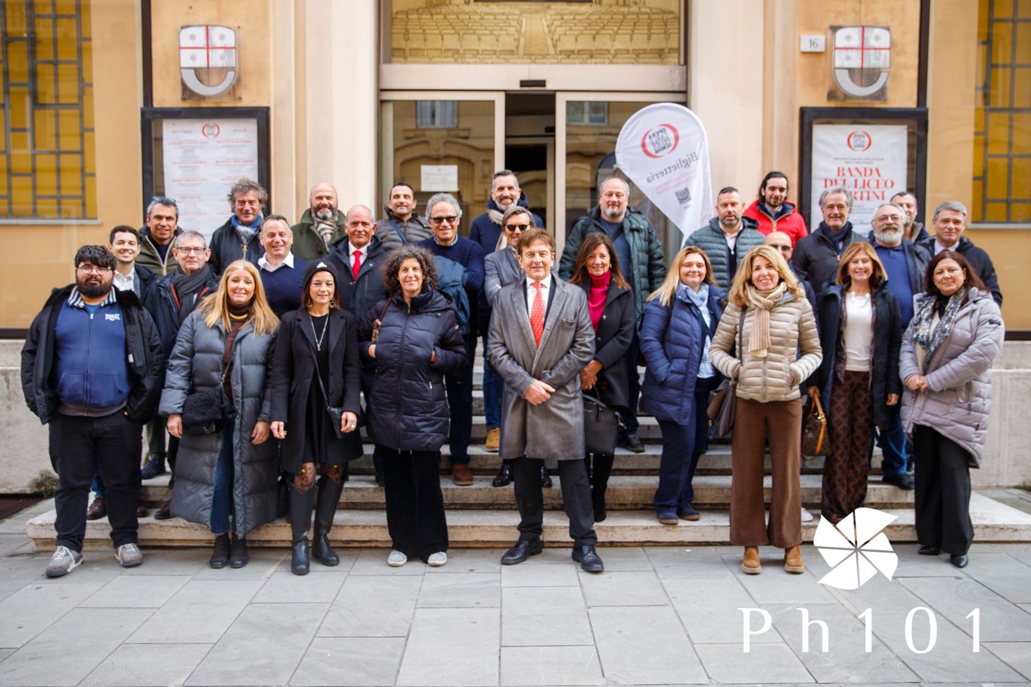 Group photo of education professionals gathered outside an institutional building.