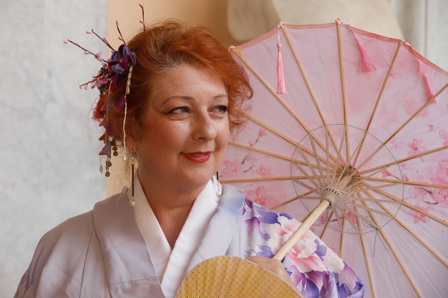 Decorative parasols in pink and purple hues against white background.