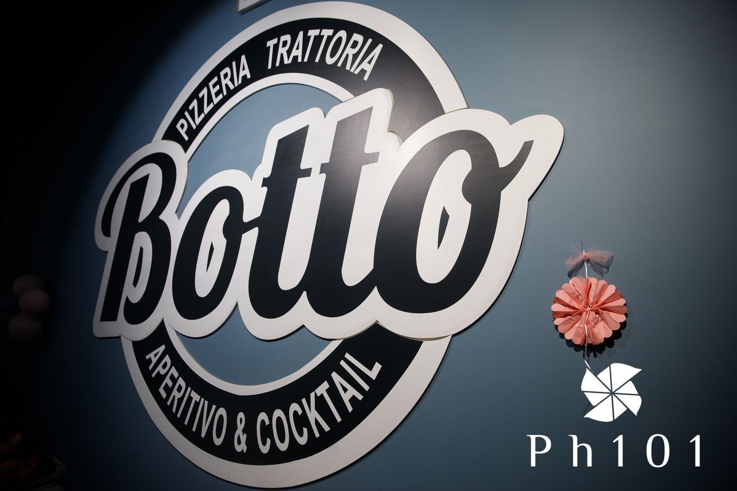 Illuminated restaurant signs and logos displayed in a dark setting.