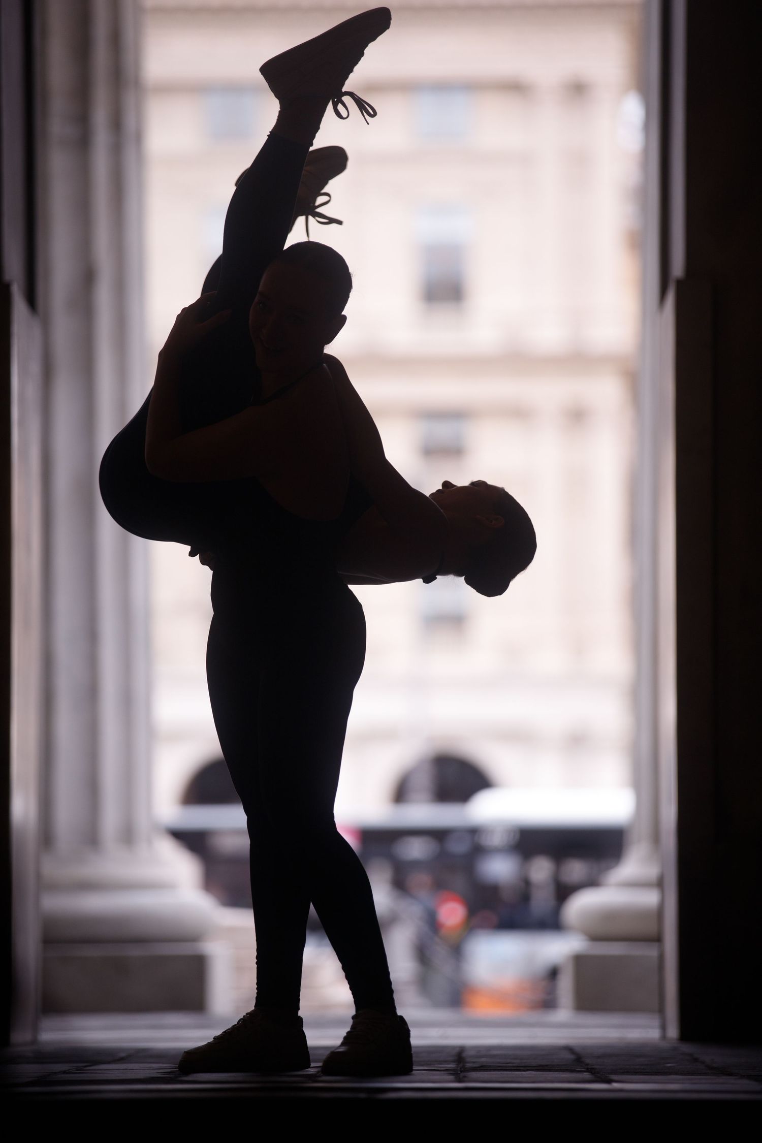 Window silhouettes showing playful poses and movements in backlit setting.