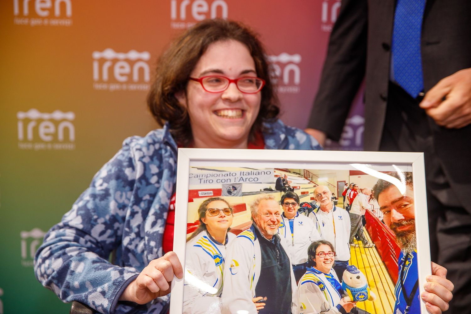 Conference presentation displays with colorful Iren company branding and signage.