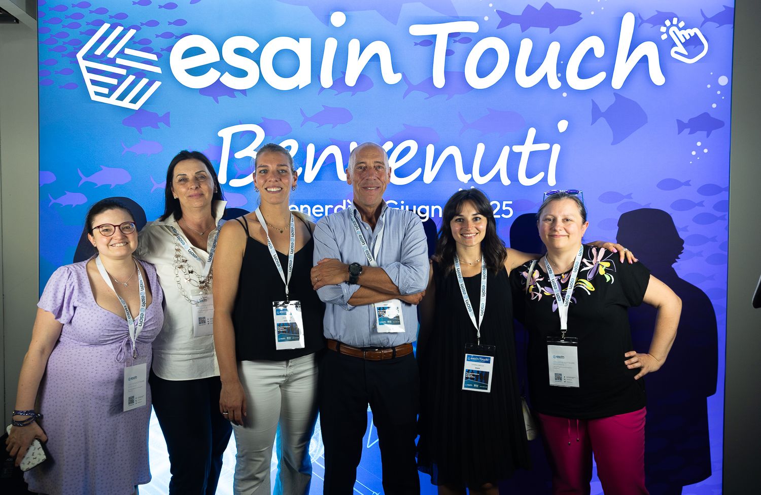 Professional conference or event with Esain Touch branding and blue lighting.