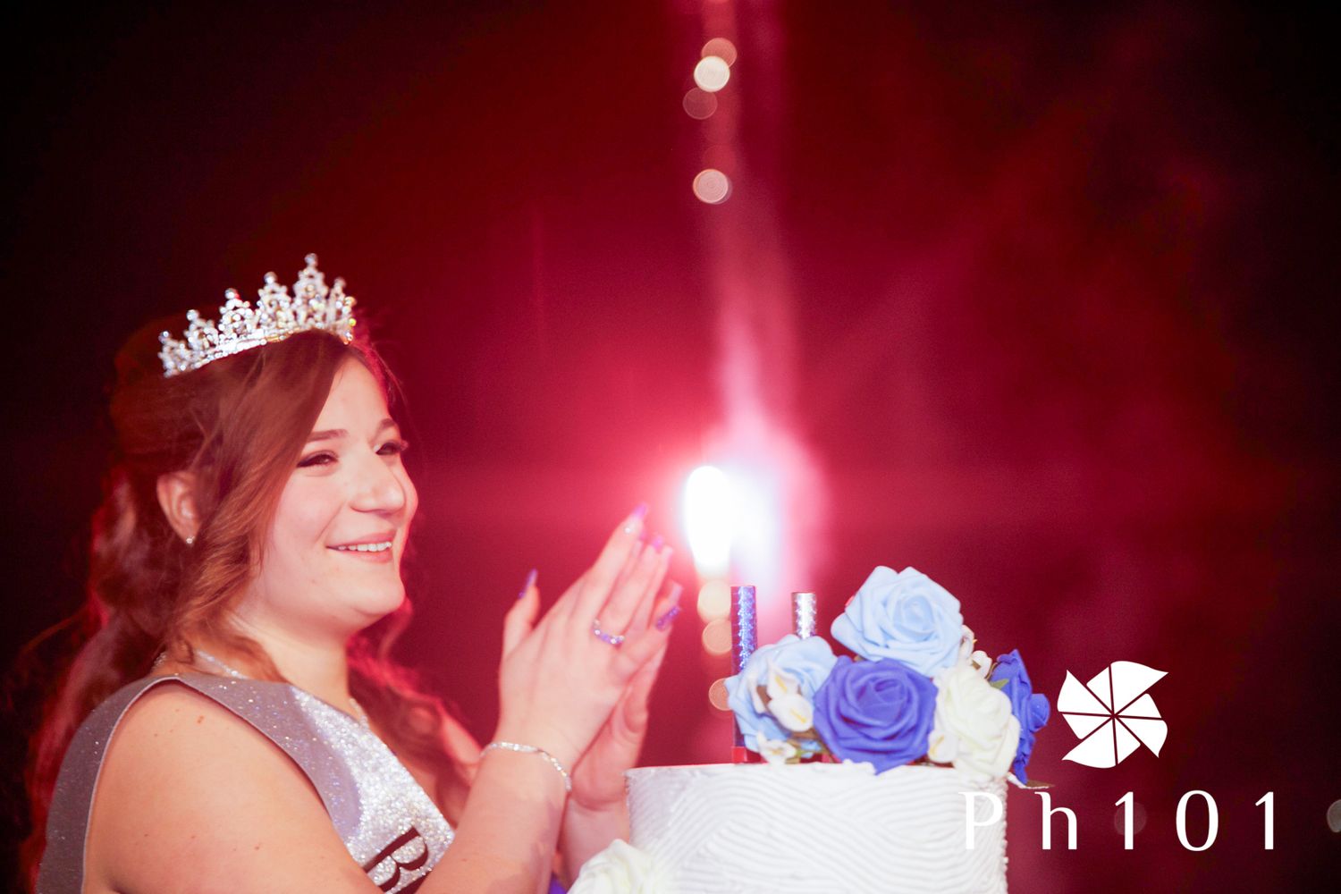 Crown silhouette against dramatic red lighting at a formal event.