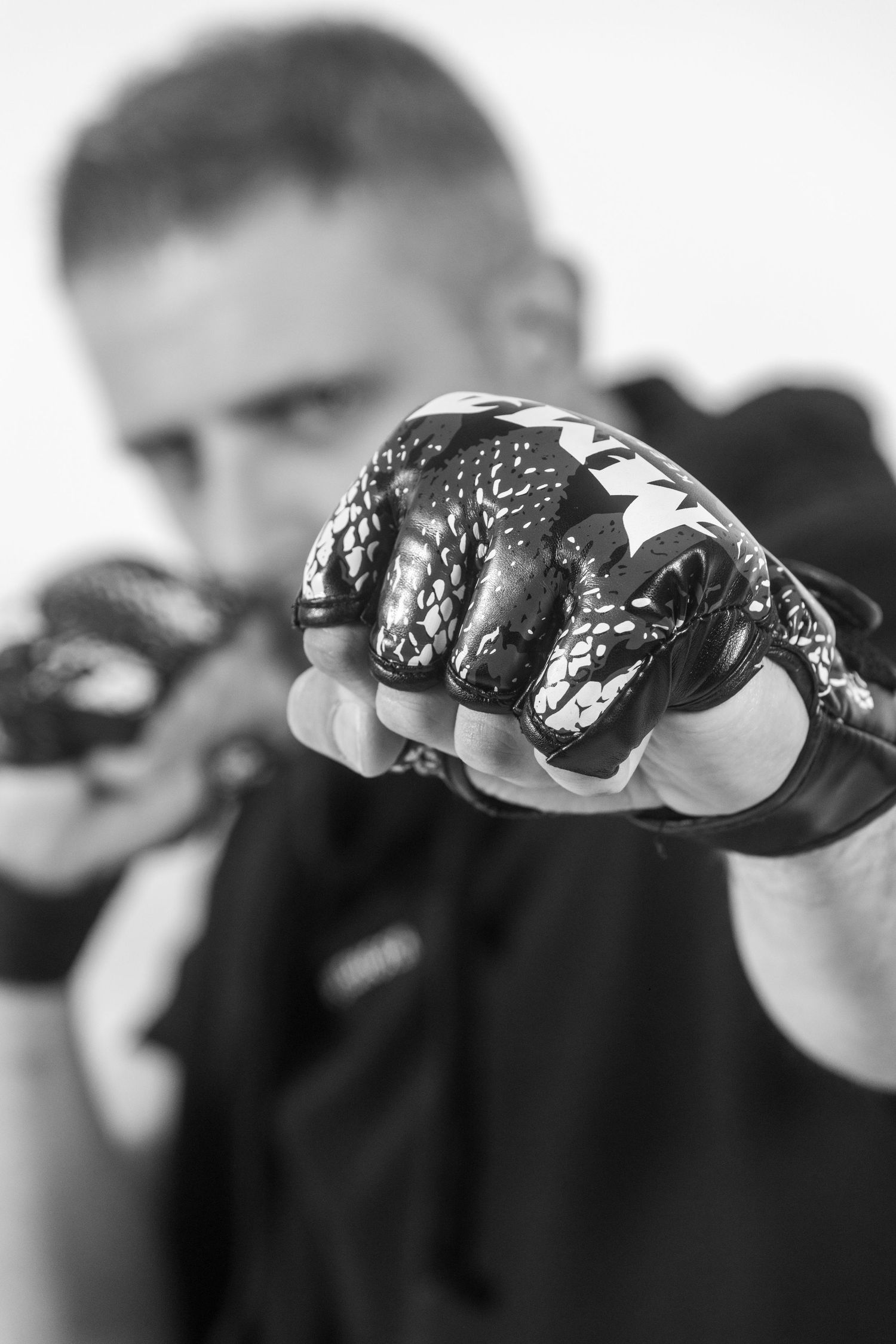 A black and white sequence of close-up photos showing a hand with a ring in different positions.