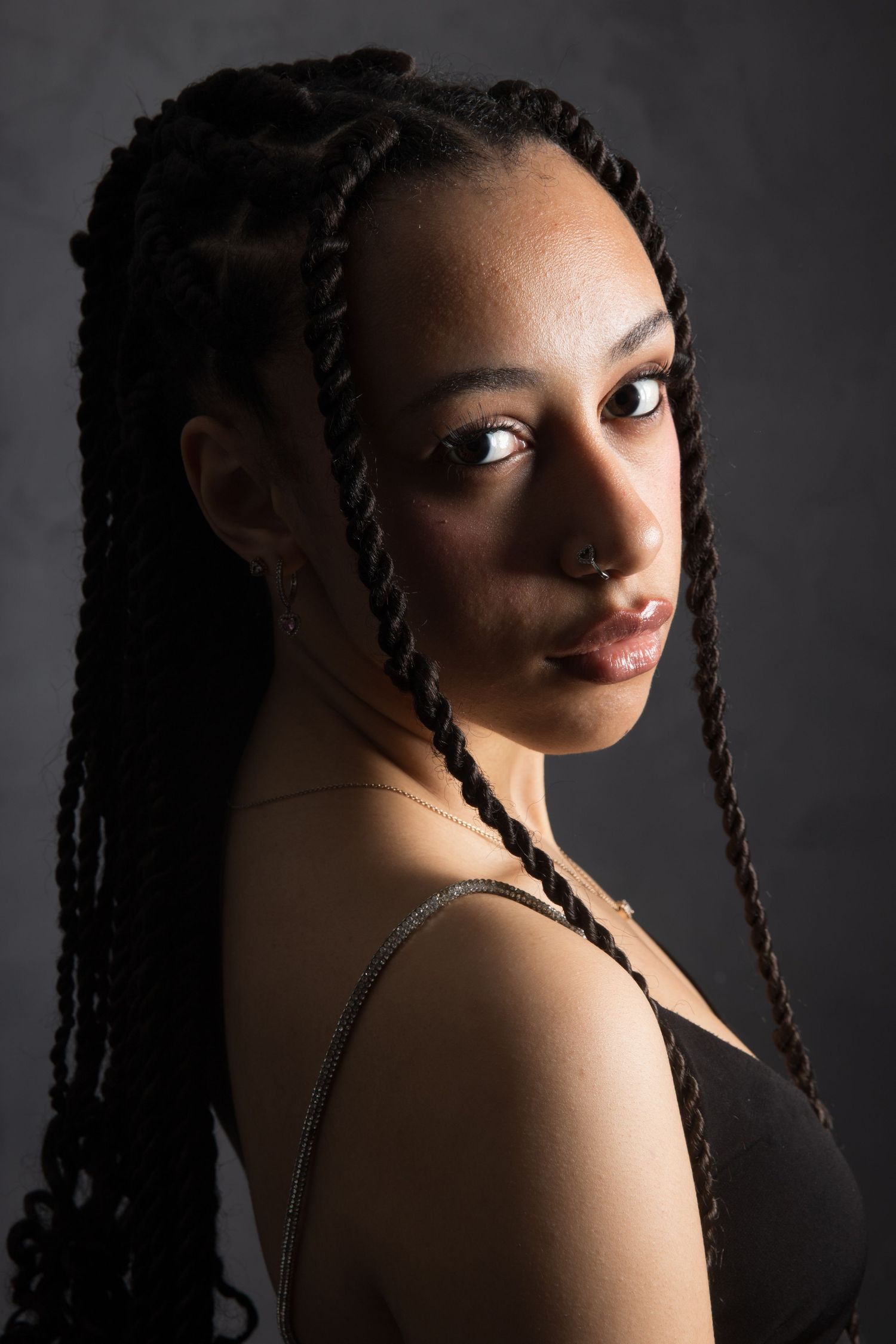 Artistic portrait series with dramatic side lighting against dark background.