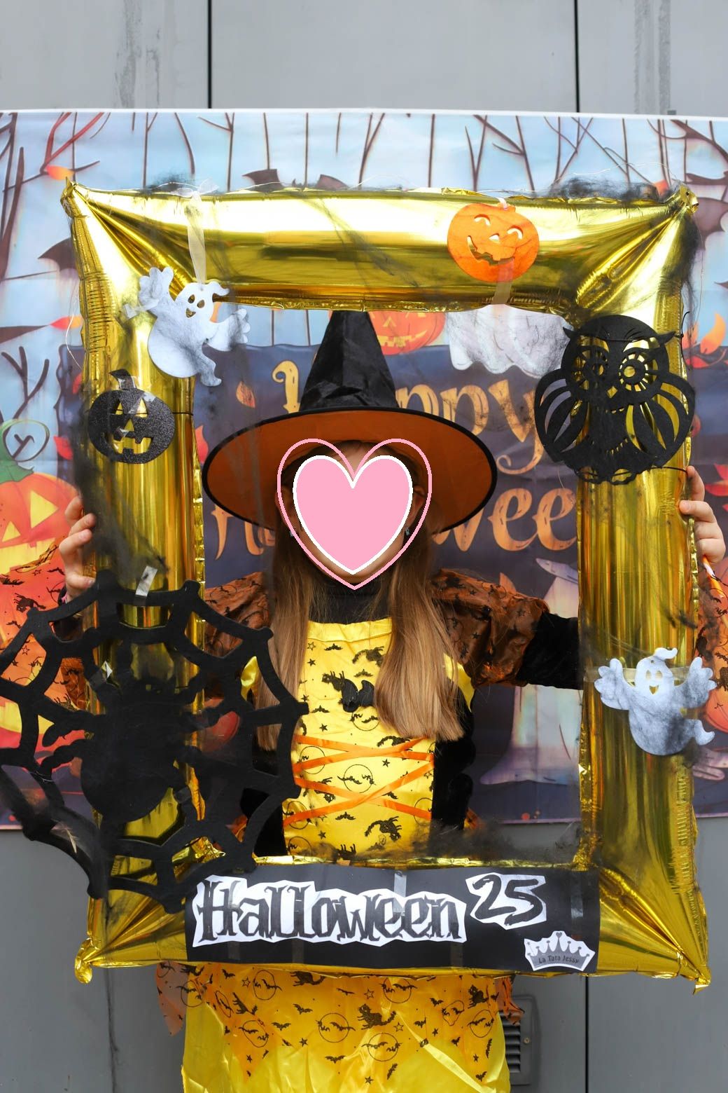 Halloween themed photo backdrop with gold stars, pumpkins and spooky decorations.