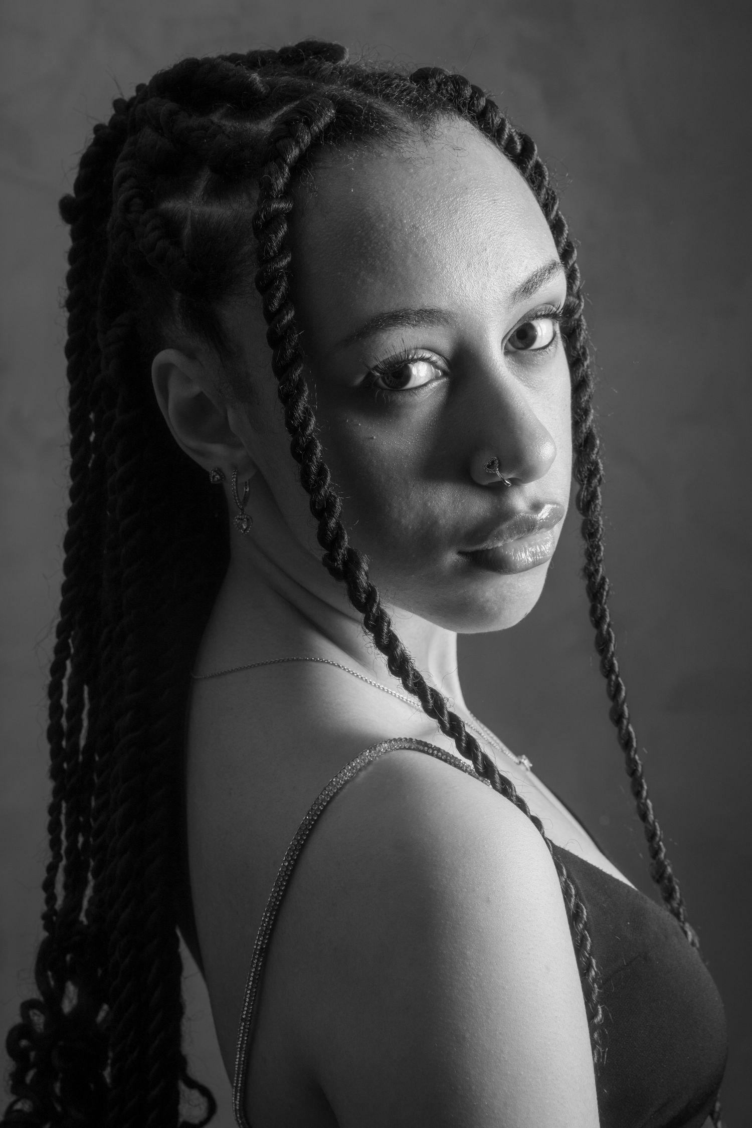 Dramatic black and white portrait series with artistic lighting and poses.