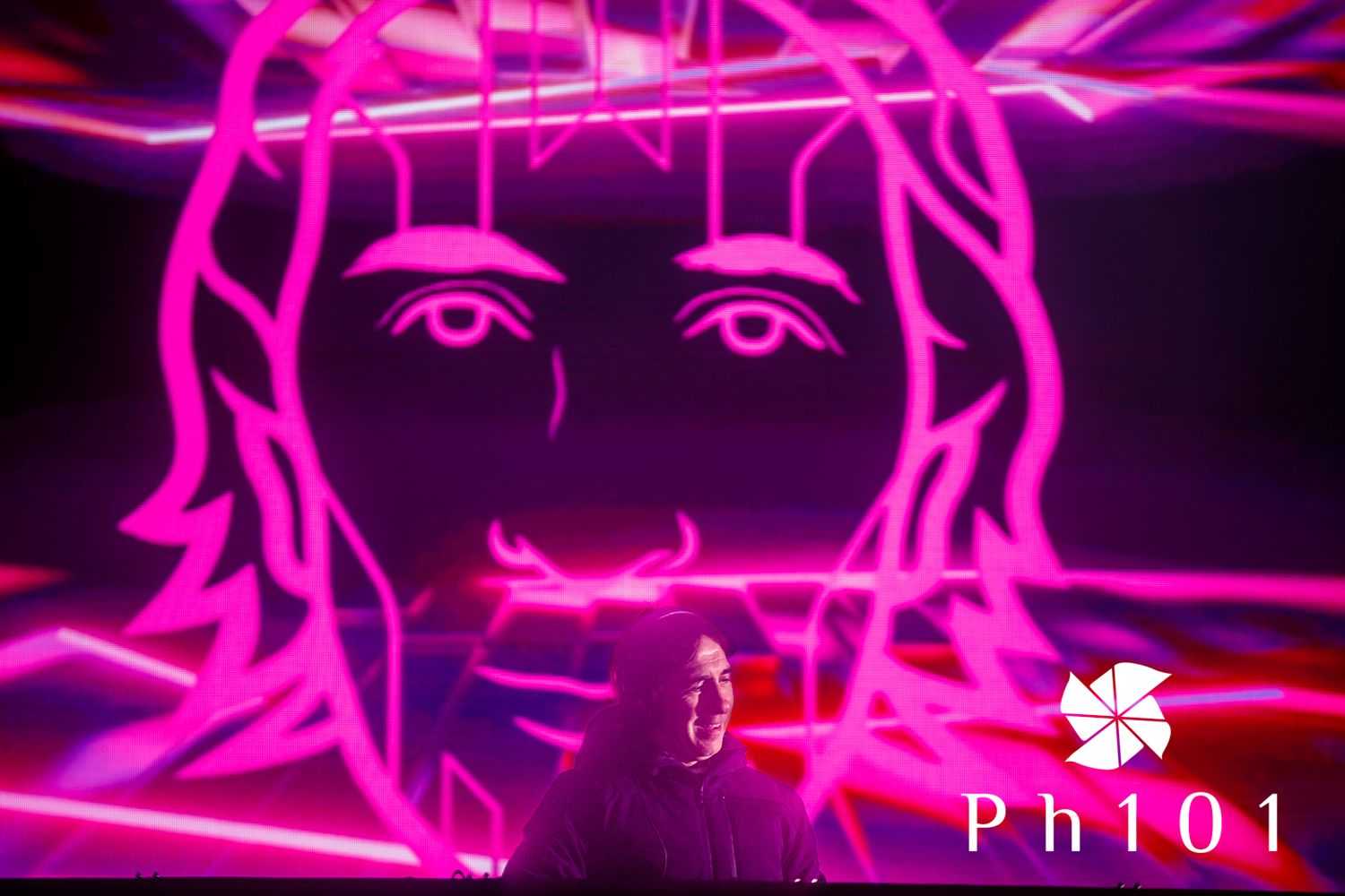 Abstract neon pink lighting design creating geometric patterns against black background.
