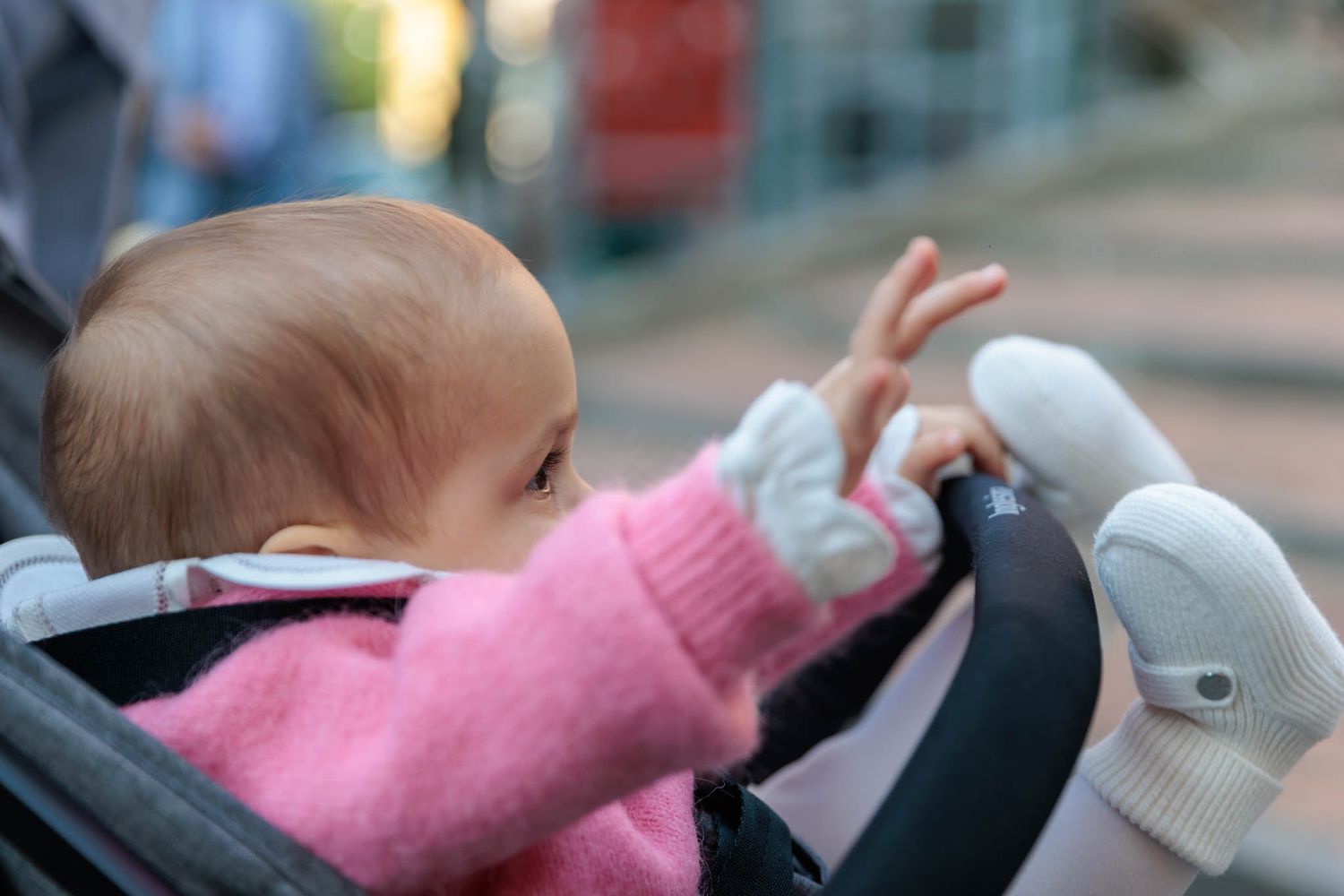 Baby in pink clothing being held and comforted in multiple candid shots.
