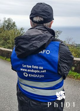 Photographer wearing blue and black jacket with endupix branding.