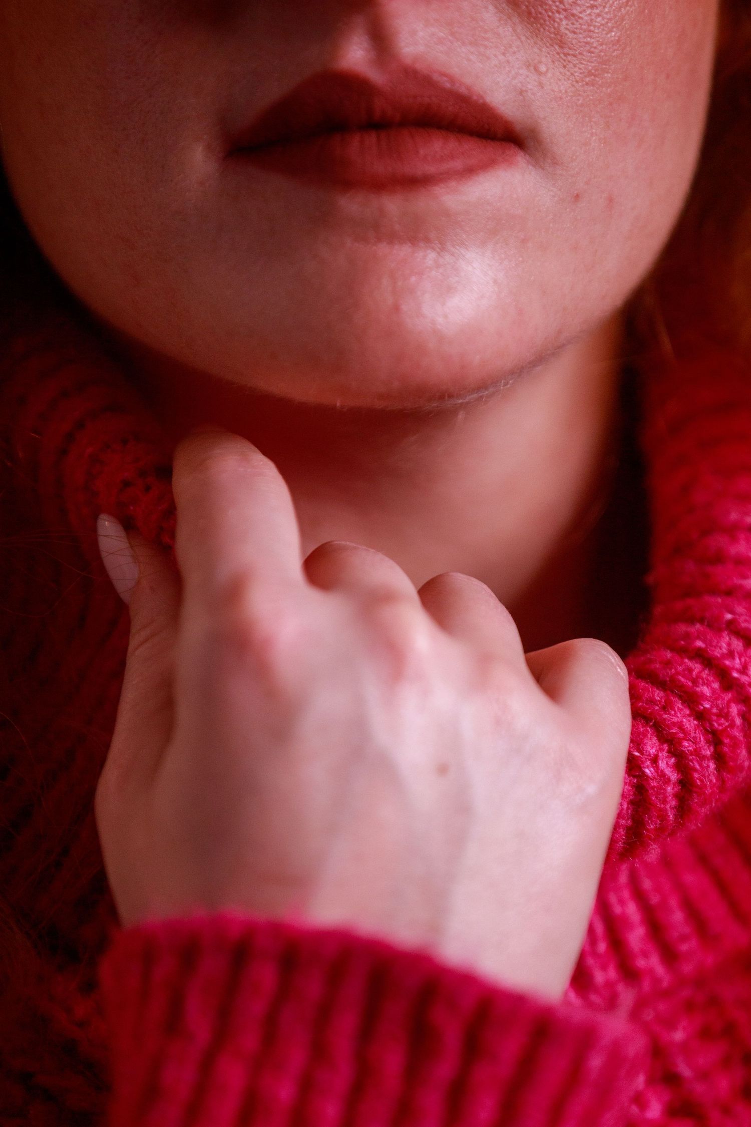 Close-up series showing neck and lower face wearing bright red sweater.