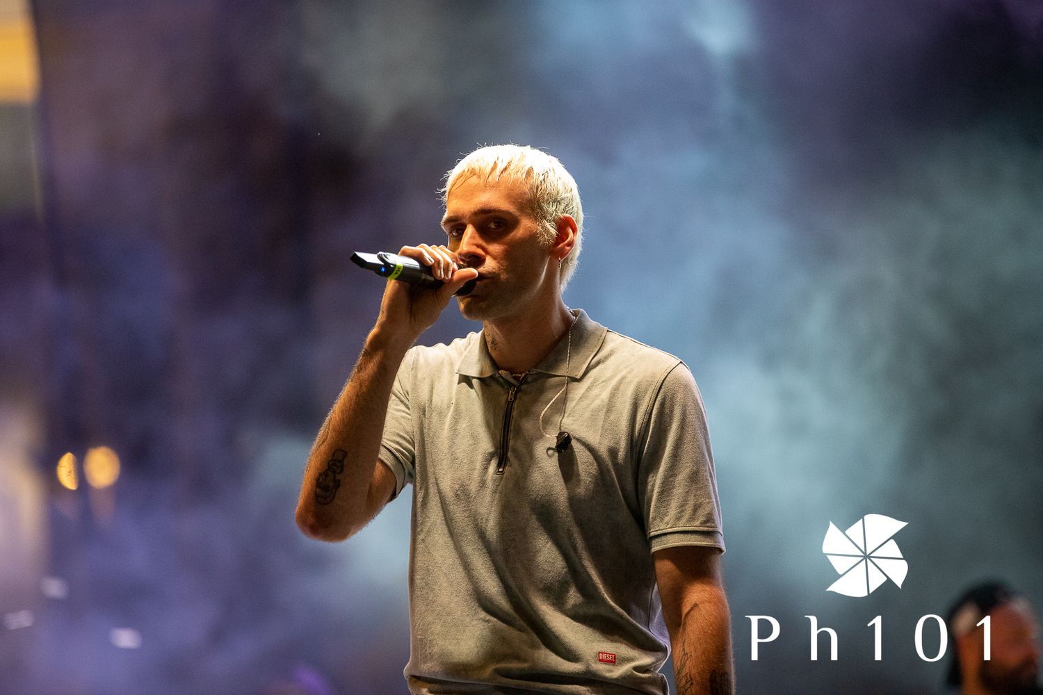 Concert performance with atmospheric blue smoke effects on stage.