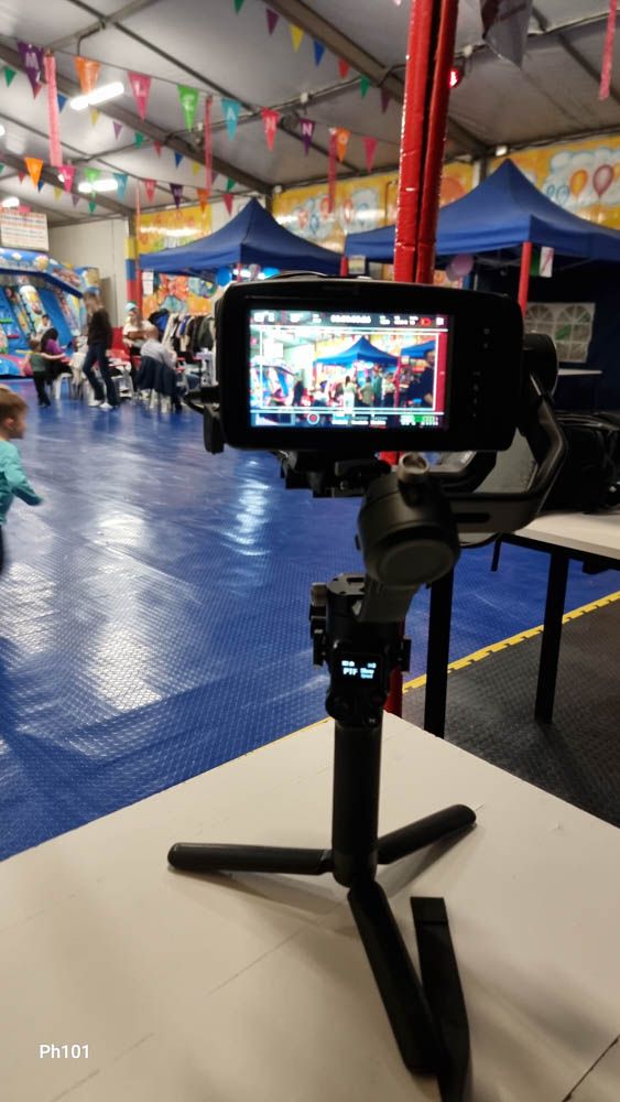 Camera equipment setup showing multiple viewfinders in an indoor venue with festive decorations.
