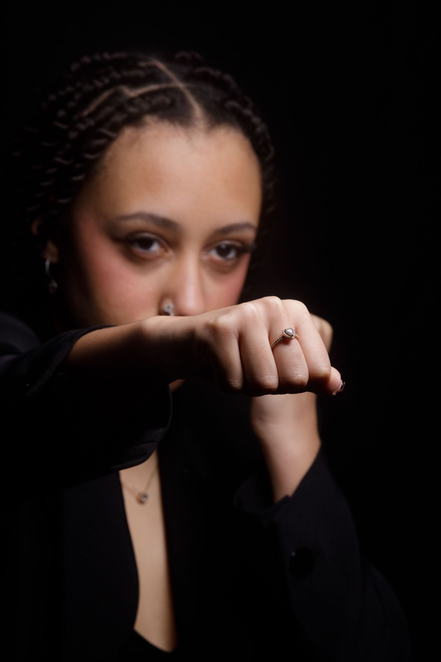 Close-up portrait series showing someone covering their face with their hands against dark background.