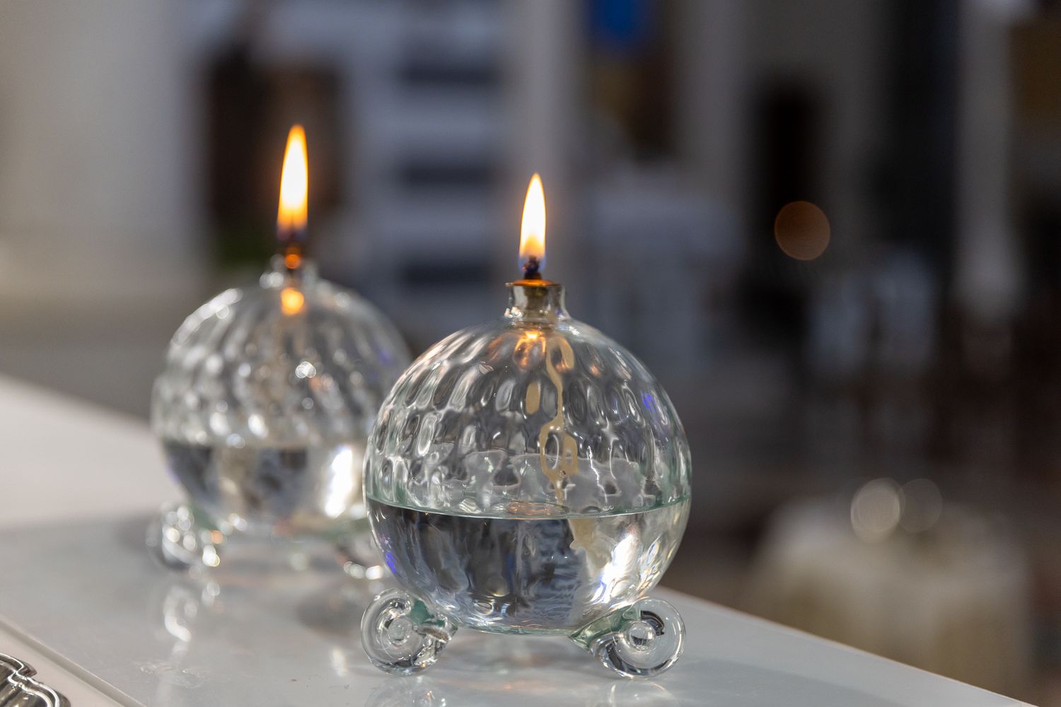 Two lit crystal oil lamps creating ambient lighting.