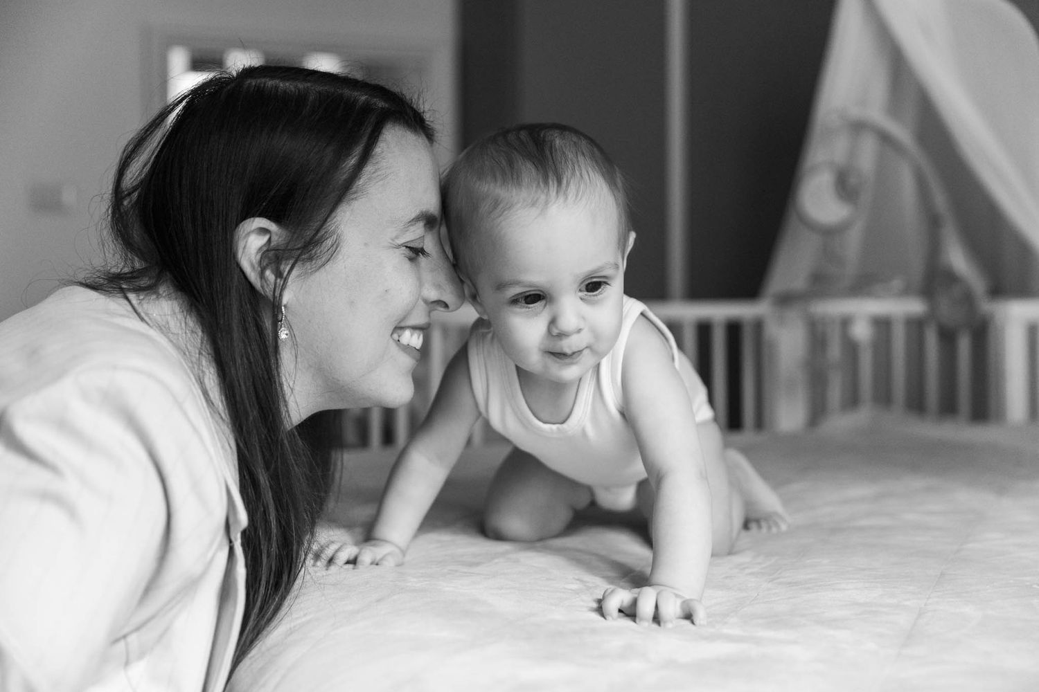 Tender black and white portrait series showing intimate moments between parent and baby.
