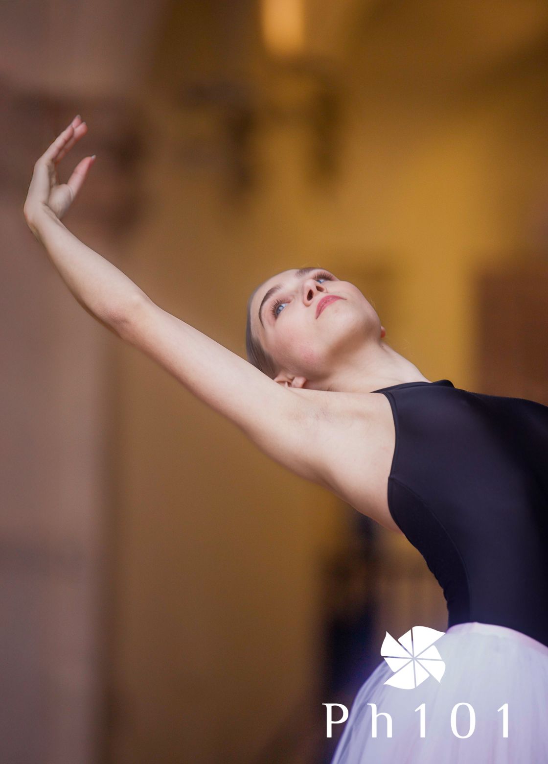 Artistic sequence of graceful dance movements in warm lighting showing raised arms and fluid motion.