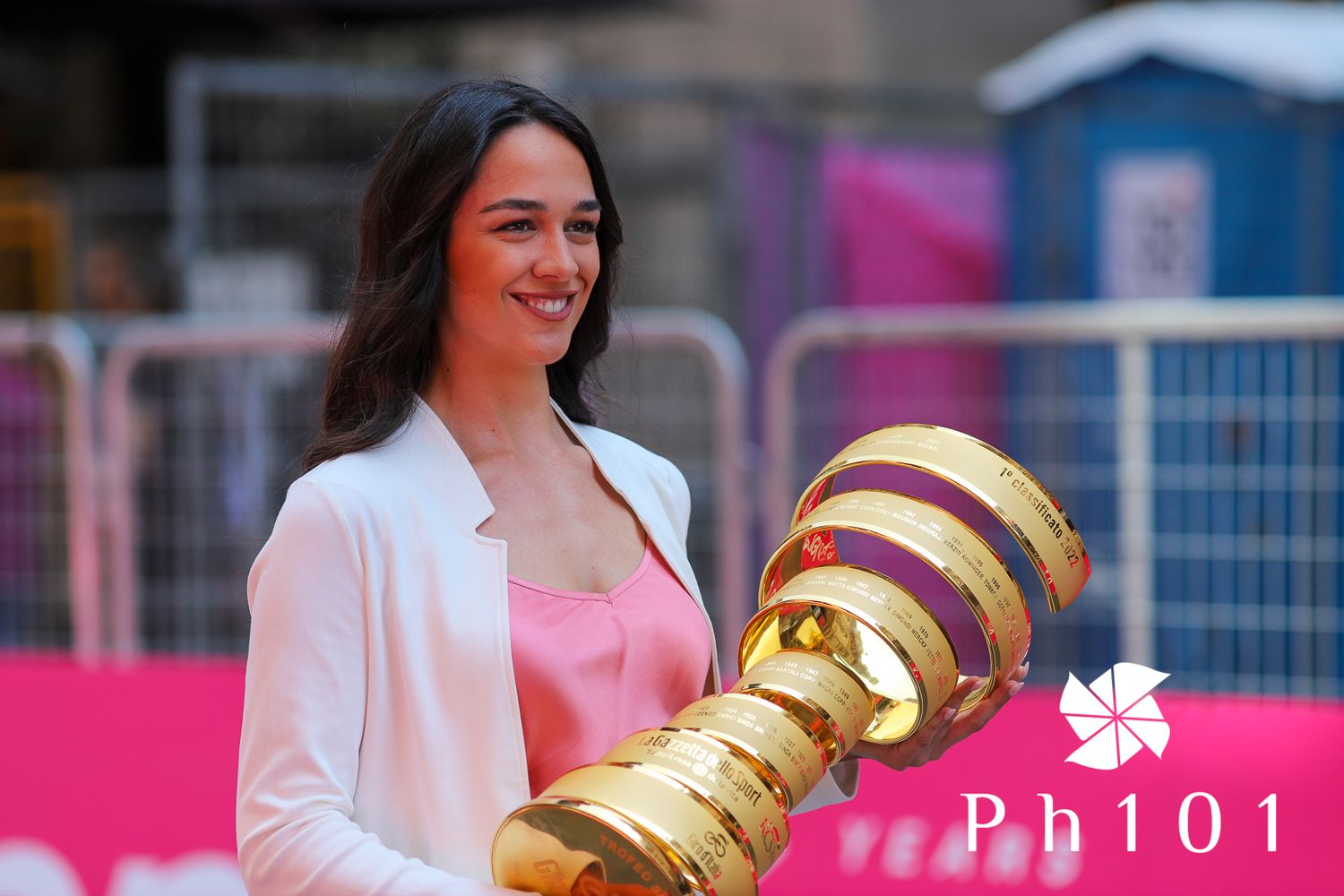 Trophy presentation featuring a large golden award at a sporting event.