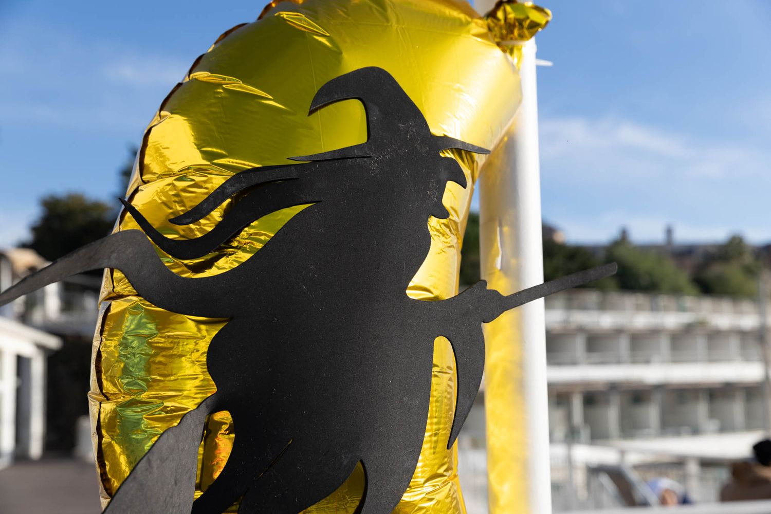 Yellow banner with black silhouette design fluttering in the breeze.